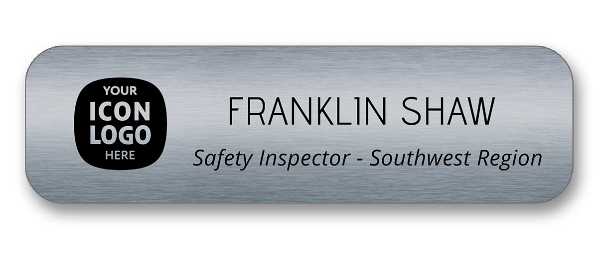 Brushed charcoal metallic employee name tag with company logo, name, and title fields — designed by Debbie Alane, wingsteps
