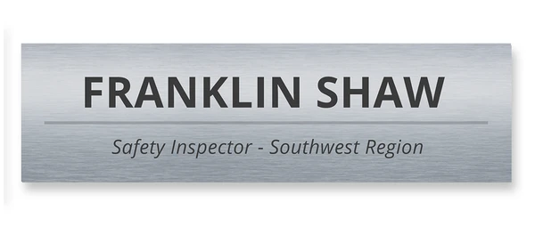 Brushed charcoal metallic name tag with bold sans-serif typography — designed by Debbie Alane, wingsteps